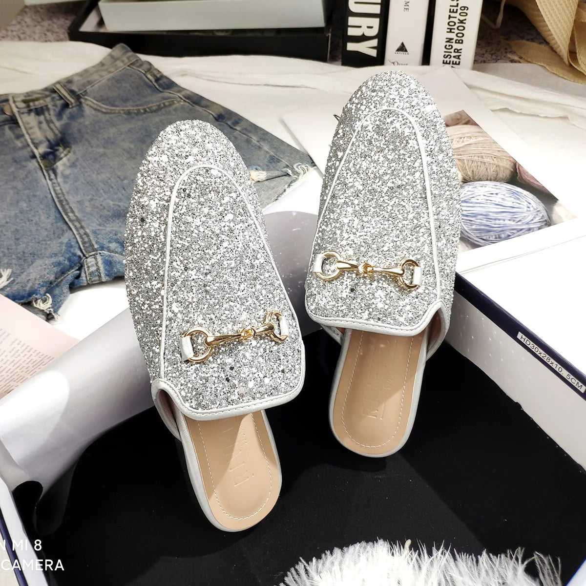 Silver glitter loafers with gold chain detail, these slip-on shoes are designed for all-day wear.