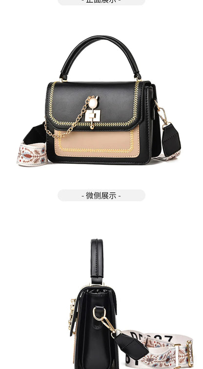 Black and tan leather handbag with gold chain detail, top handle, and patterned strap.