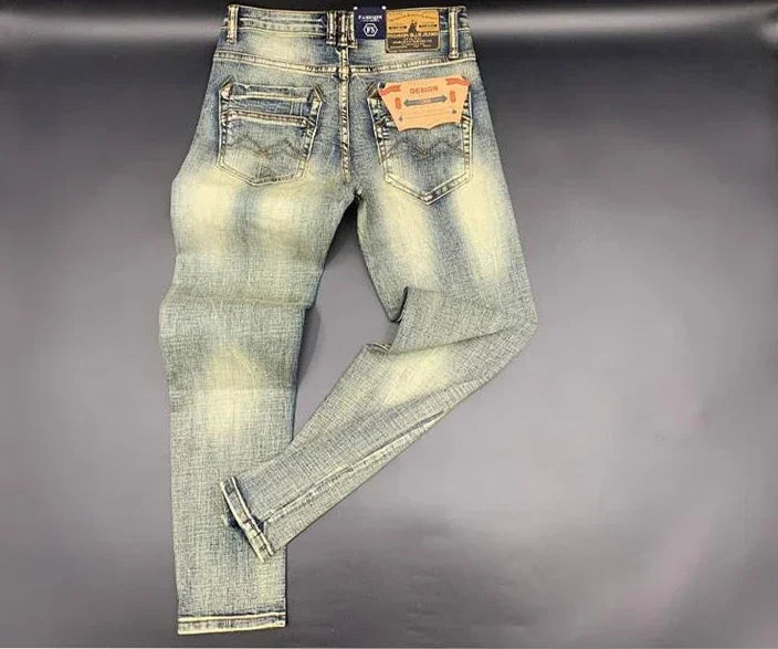 Faded blue tapered jeans in stretchy denim with back pockets and a back label for daily comfort.