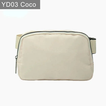 Beige waterproof crossbody with suede trim, zip closure, and adjustable strap for running and yoga.