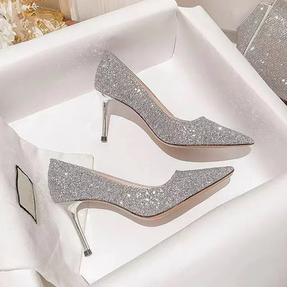 Silver glitter pointed-toe dress shoes with slim heels for weddings.