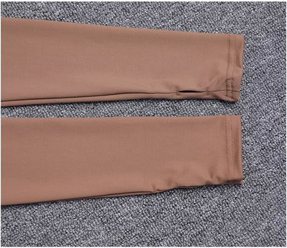 Brown stretchy polyester long sleeve sport jacket with thumbholes for yoga training.