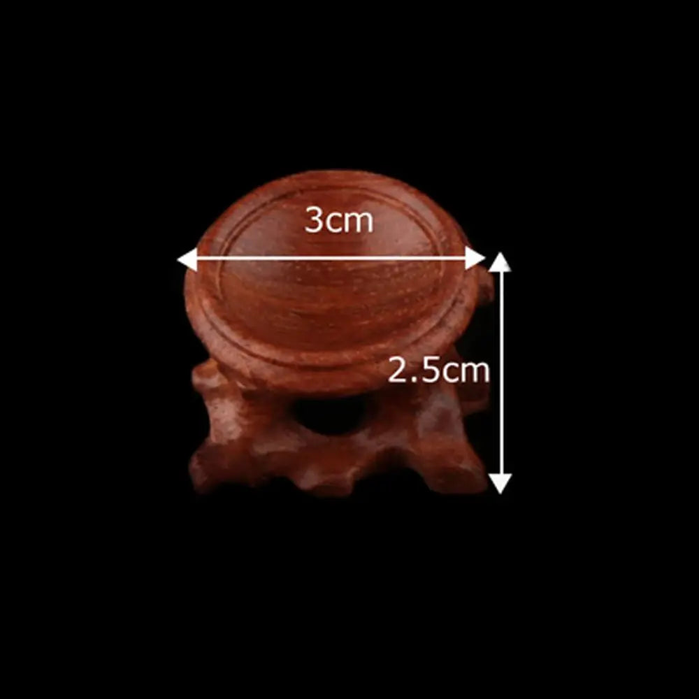 Brown wooden crystal ball stand with a 3cm diameter recess and 2.5cm height, featuring a carved base.