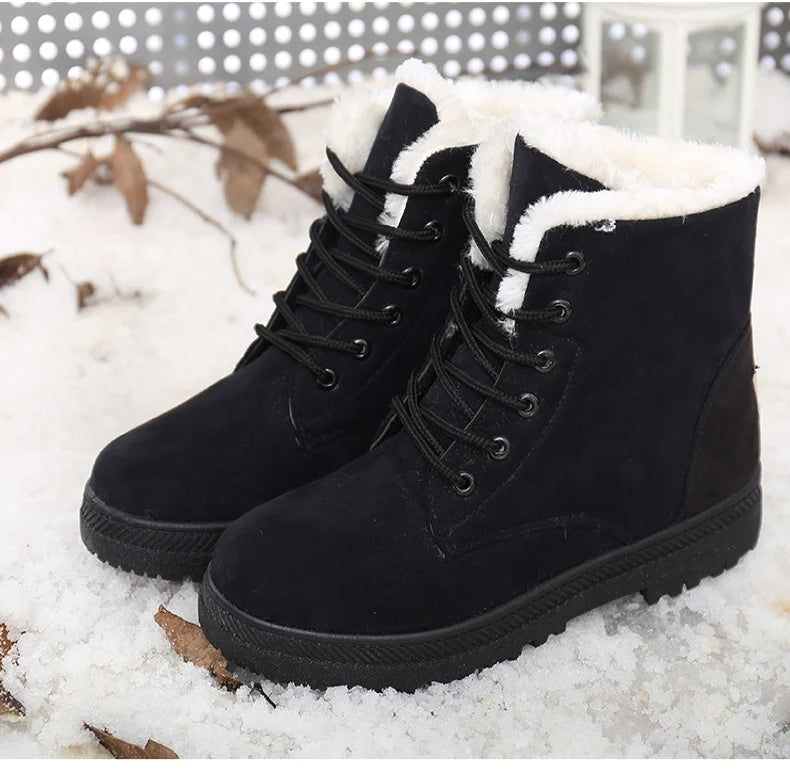 Black suede ankle boots with white faux fur lining, black laces, and textured rubber soles.