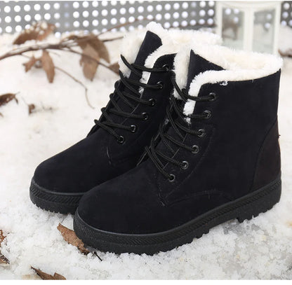 Black suede ankle boots with white faux fur lining, black laces, and textured rubber soles.