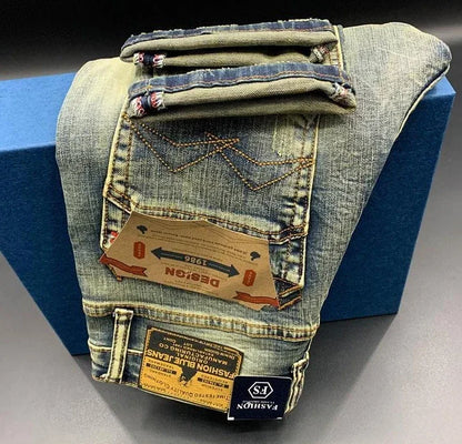 Stretchy blue denim tapered jeans with contrast stitching and pocket tags for daily wear.