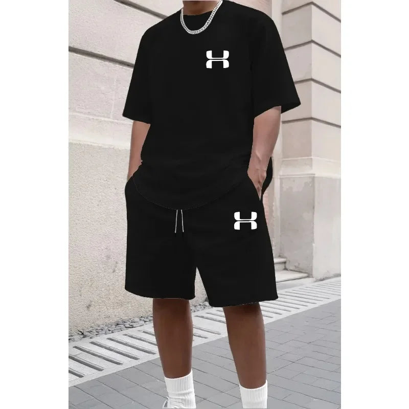 Black relaxed knit set with logo, short sleeve tee, and athletic shorts for workouts.