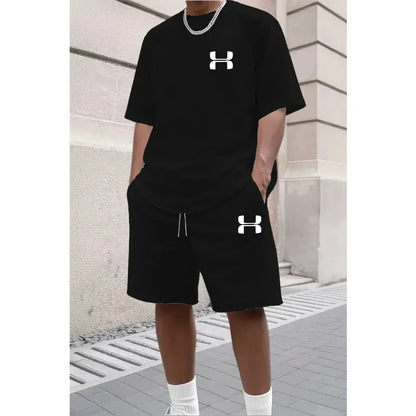 Black relaxed knit set with logo, short sleeve tee, and athletic shorts for workouts.