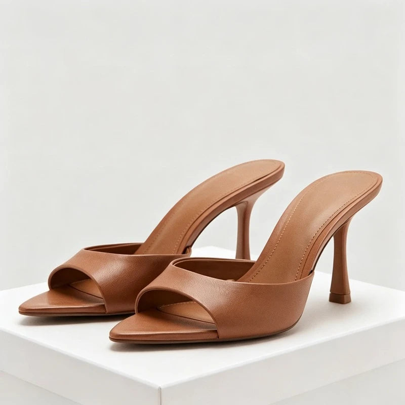 Tan faux leather slip-on open toe sandals with a thin heel for parties.