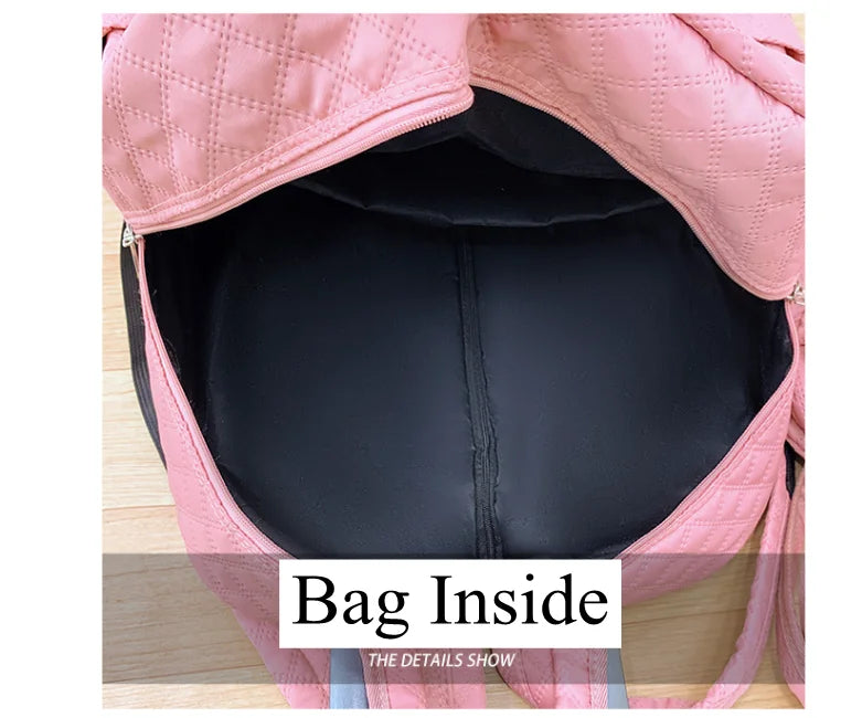 Open interior of a quilted pink rolling travel backpack, showing black fabric lining and a pocket.