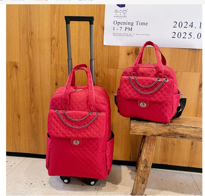 Red quilted nylon rolling backpack and matching handbag with chain accent and twist-lock front pocket.