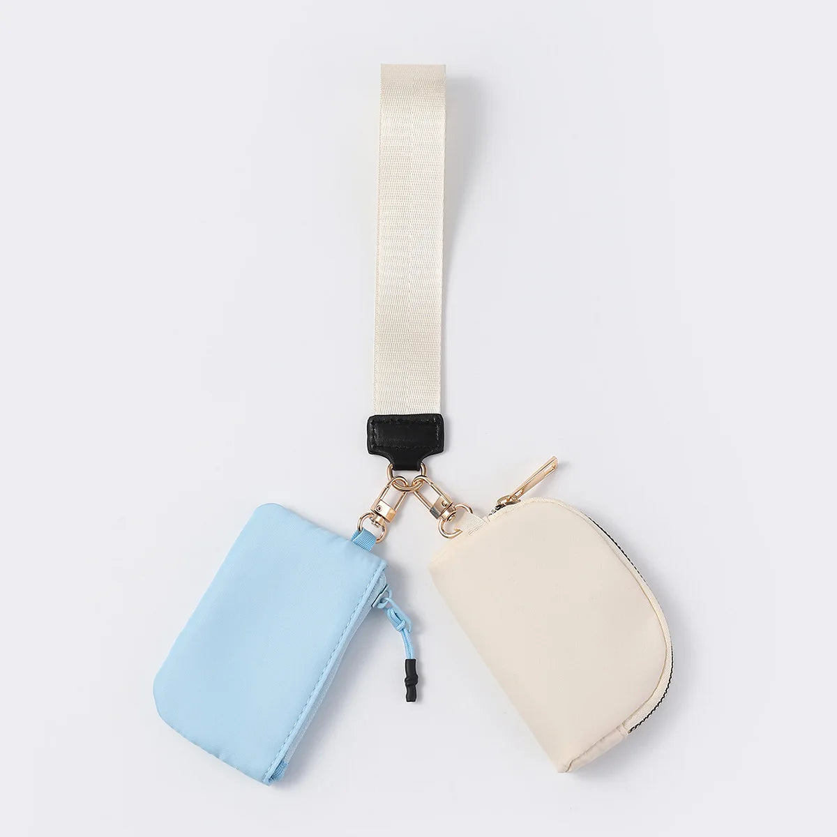 Blue and cream waterproof wristlet wallet with zip closure pouches for carrying everyday essentials.