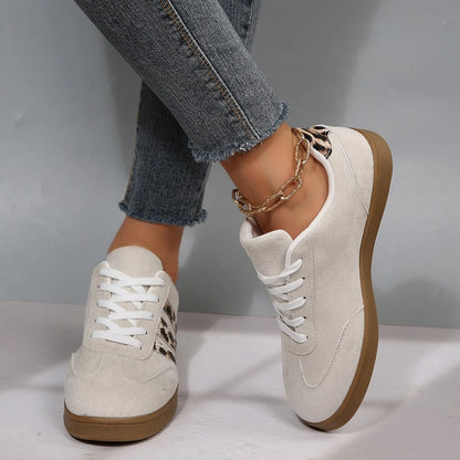 Beige suede slip-on sneakers with leopard print details and cushioned soles for comfortable daily walking.