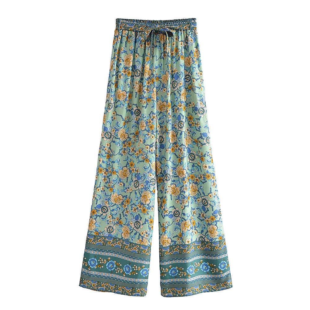 Mint green floral flowy wide leg pants with a drawstring waist for beach vacations.