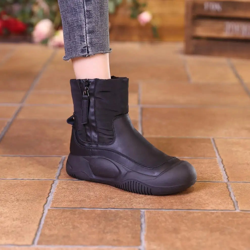 Black winter ankle boot with side zipper, smooth lower, quilted upper, and thick chunky sole.