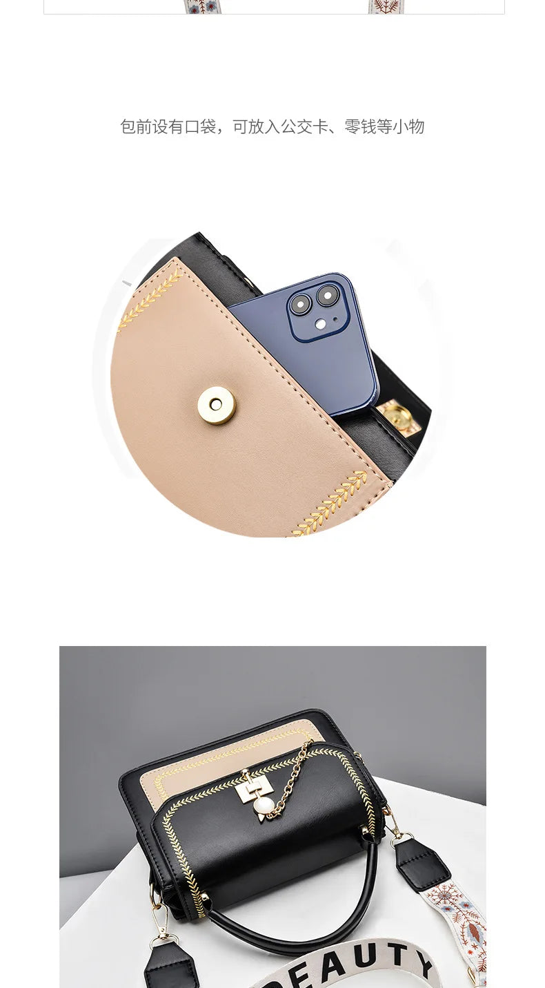Black and beige leather shoulder bag featuring gold embroidery, a front pocket, and a decorative chain.