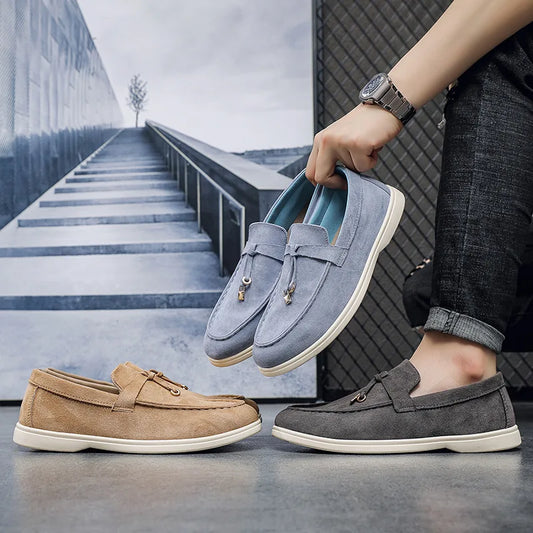 Blue, tan, and grey suede slip-on loafers with gold charms, featuring a cushioned sole for everyday wear.