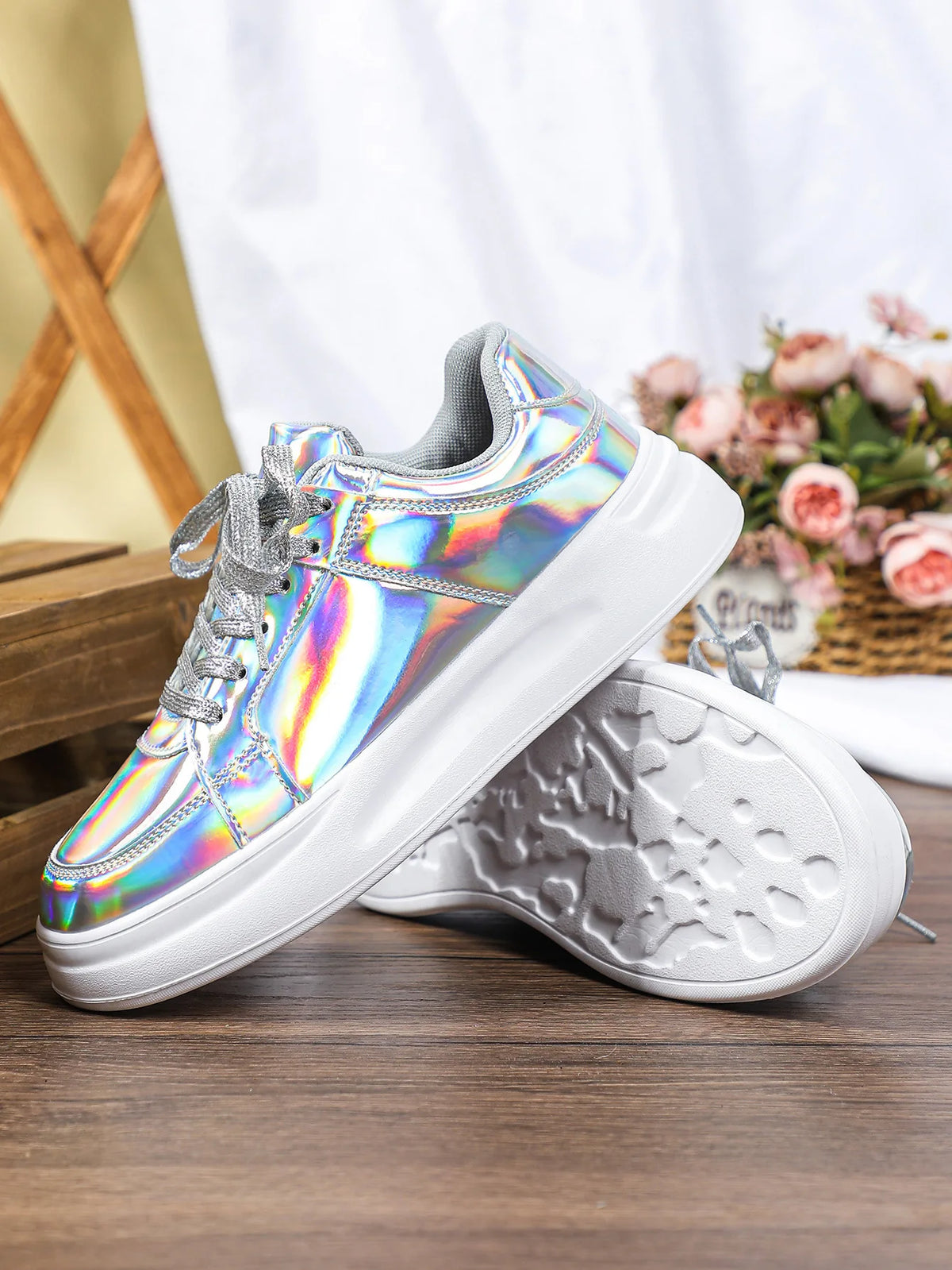 Silver holographic lace-up casual sneakers with thick white soles and textured tread.