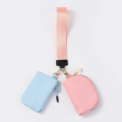 Pink and blue nylon dual pouch wristlet wallet with zip closure for holding cards and keys on the go.