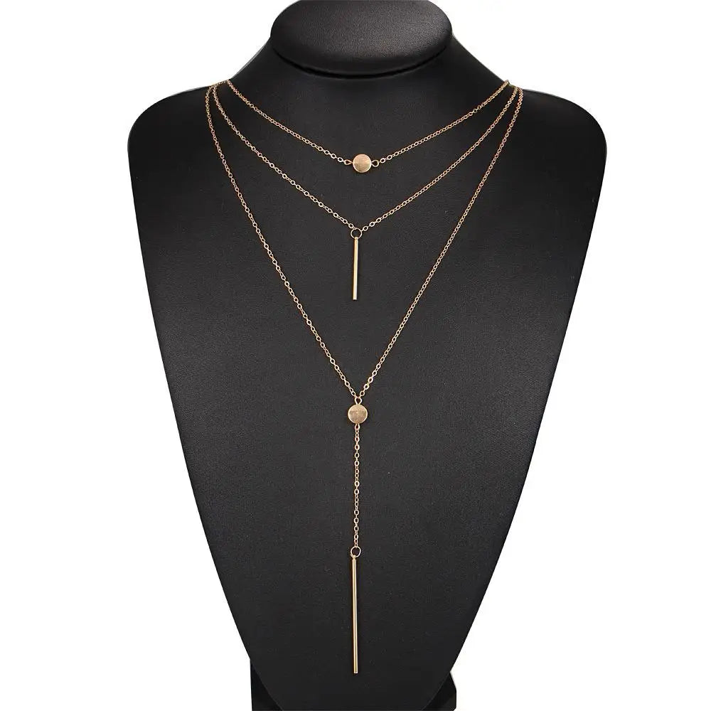 Women's gold-tone layered chain necklace with pendant detail