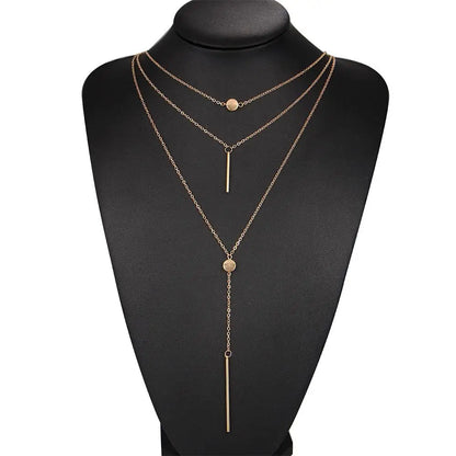 Women's gold-tone layered chain necklace with pendant detail