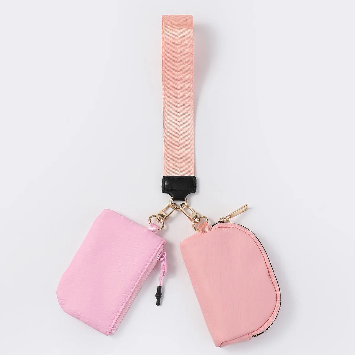 Pink nylon dual pouch with a zip closure and wrist strap for organized daily carry.