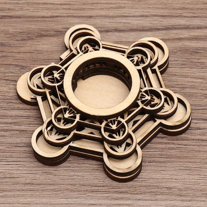 Brown wooden crystal ball holder with intricate sacred geometry and lotus pattern cutouts.