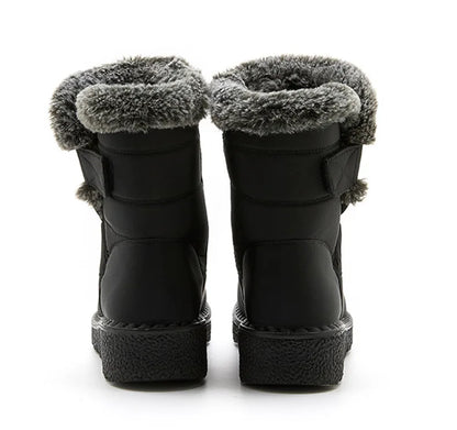 Black winter boots featuring gray faux fur trim, low heels, and hook-and-loop side straps.