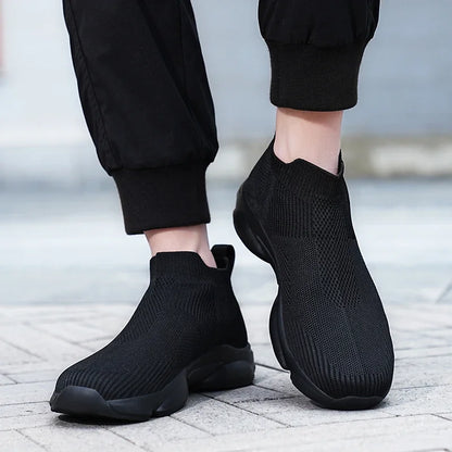 Black breathable knit slip-on sneakers with cushioned soles for daily casual wear.
