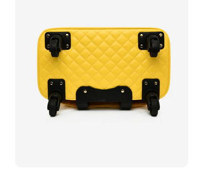 Yellow quilted travel bag bottom showing four black swivel wheels.