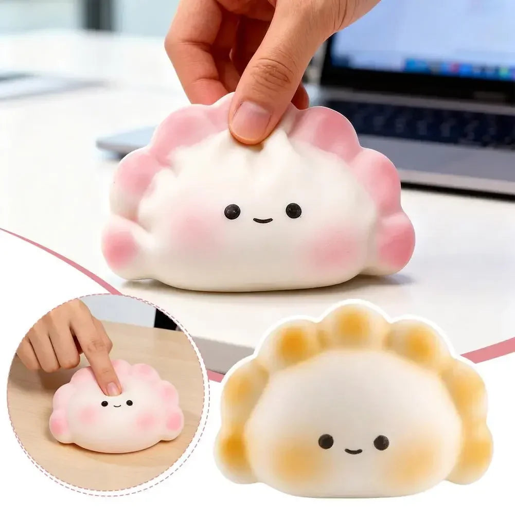 Soft pink and white dumpling squishy fidget toy for desk stress relief with a portable, squeezable design.