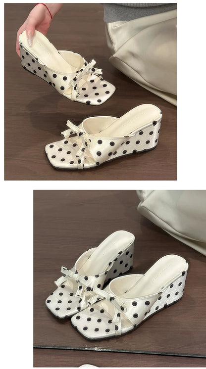 White polka dot wedge heel sandals with a bow and cushioned insole for casual wear.