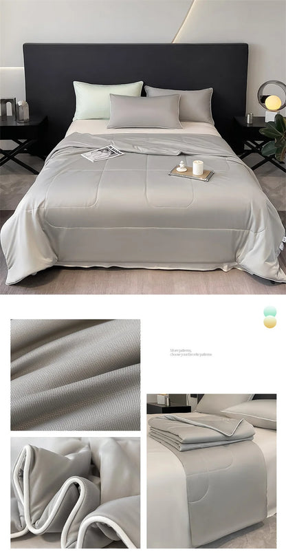 Light grey breathable cooling comforter with piped edges for a comfortable sleep on a modern bed.