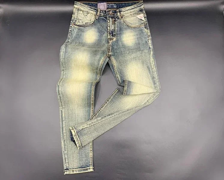 Light blue faded wash tapered jeans in stretchy denim with a button fly for daily comfort.