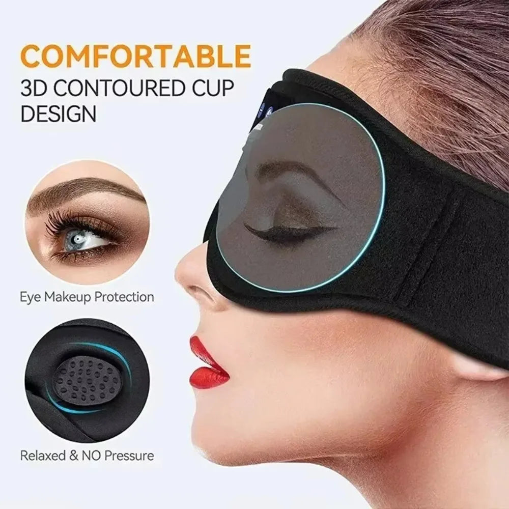 Black soft fleece Bluetooth sleeping eye mask with 3D contoured cups worn on a person's head.