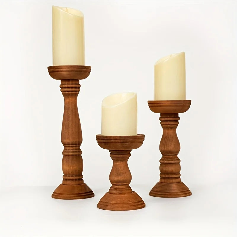 Wooden candle holders trio table centerpiece featuring turned wood pillar stands holding candles