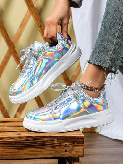 Holographic metallic lace-up sneakers with chunky white soles and shimmering silver laces.