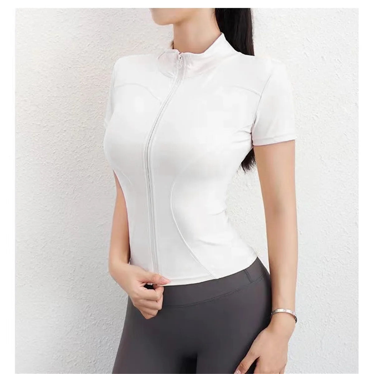 White polyester fitted sports jacket with a front zip for running, cycling, and yoga.
