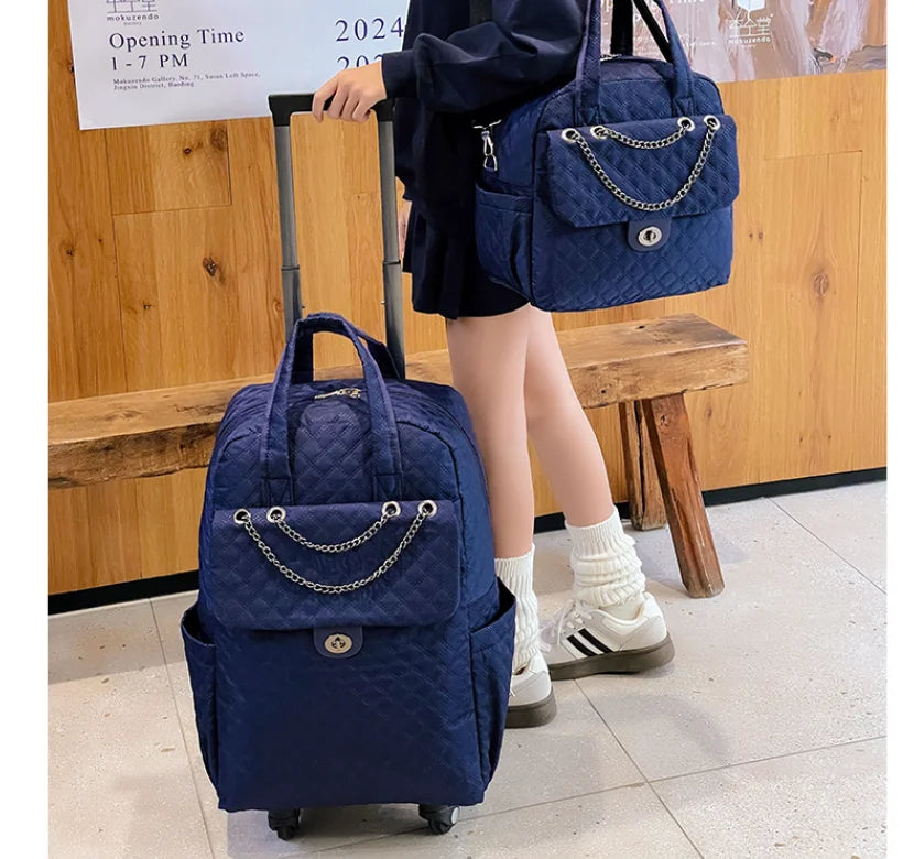 Blue quilted rolling backpack and matching handbag with chain strap detail.