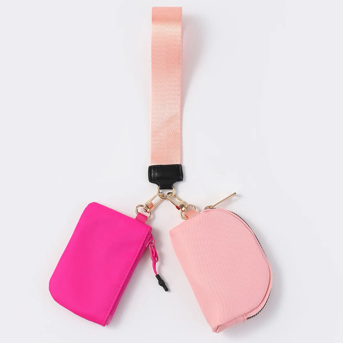 Pink nylon dual pouch with a zip closure and wrist strap for carrying daily essentials in this waterproof wristlet.