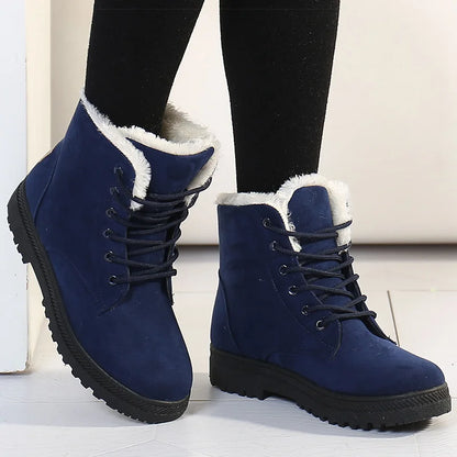 Blue suede lace-up ankle boots with white faux fur lining and black lug soles.