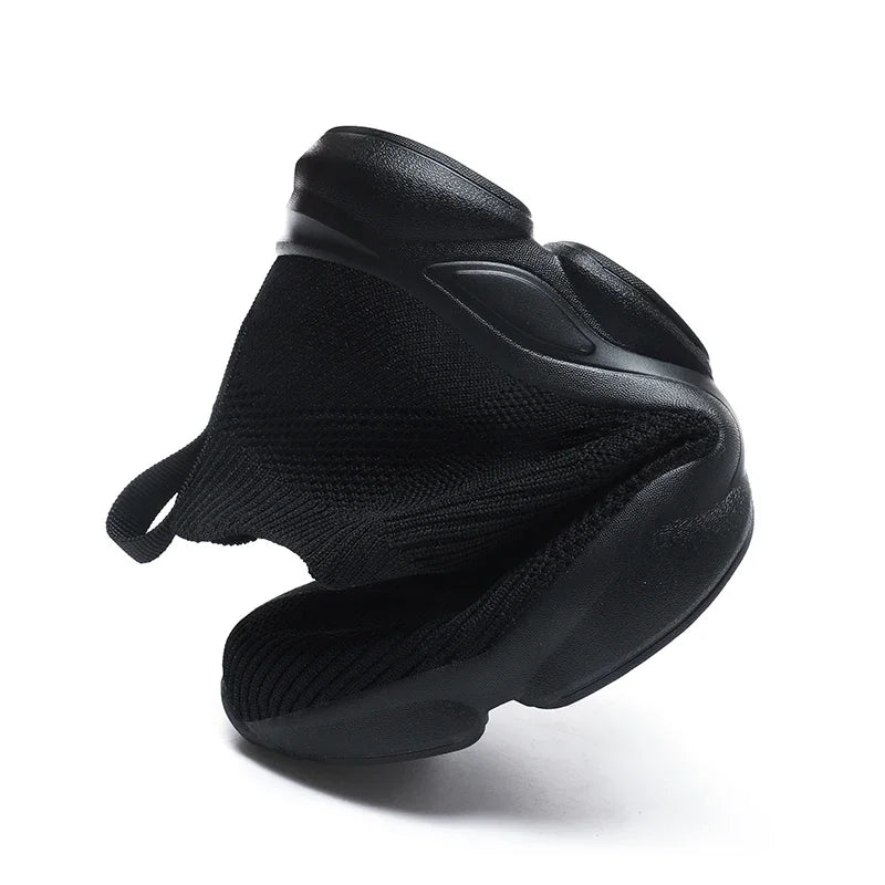 Black breathable knitted slip-on sneakers with a flexible sole for comfortable everyday walking.