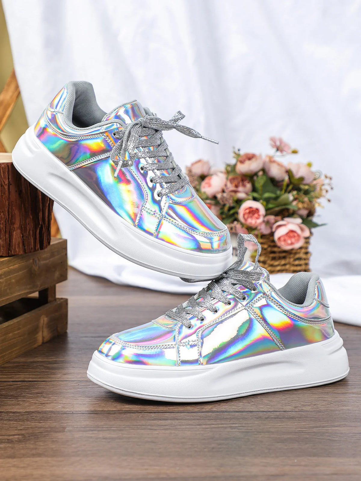 Silver holographic lace-up casual sneakers with thick white soles and glittery laces.