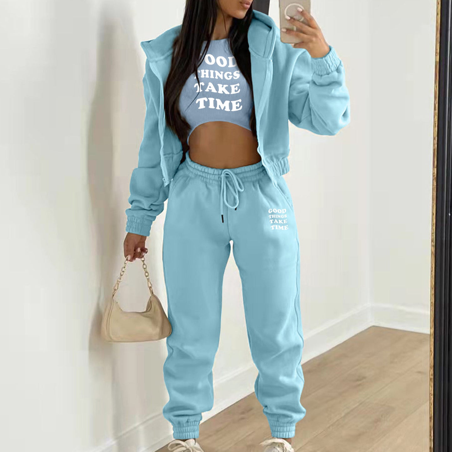 Light blue knit sweater set with letter print, hooded zip jacket, and high waist joggers for a comfortable lounge outfit.