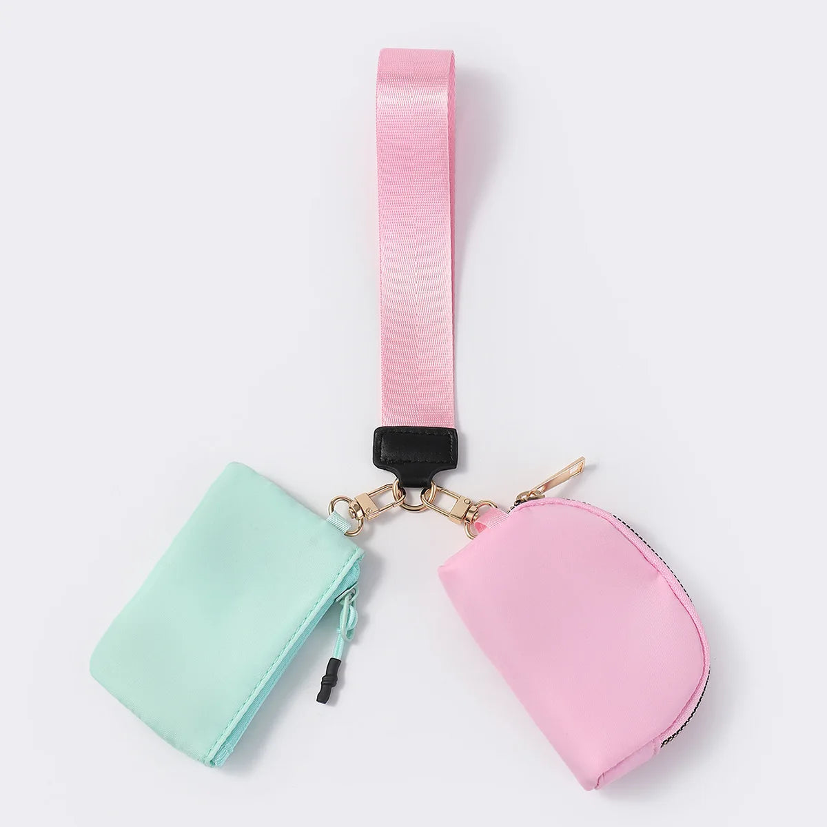Mint and pink nylon dual pouch wristlet with zip closure for carrying cards and keys while on the go.