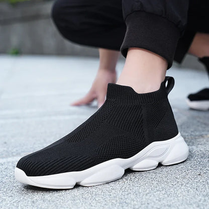 Black knit moccasin sneaker with breathable cotton lining and white non-slip sole for comfortable everyday walking.