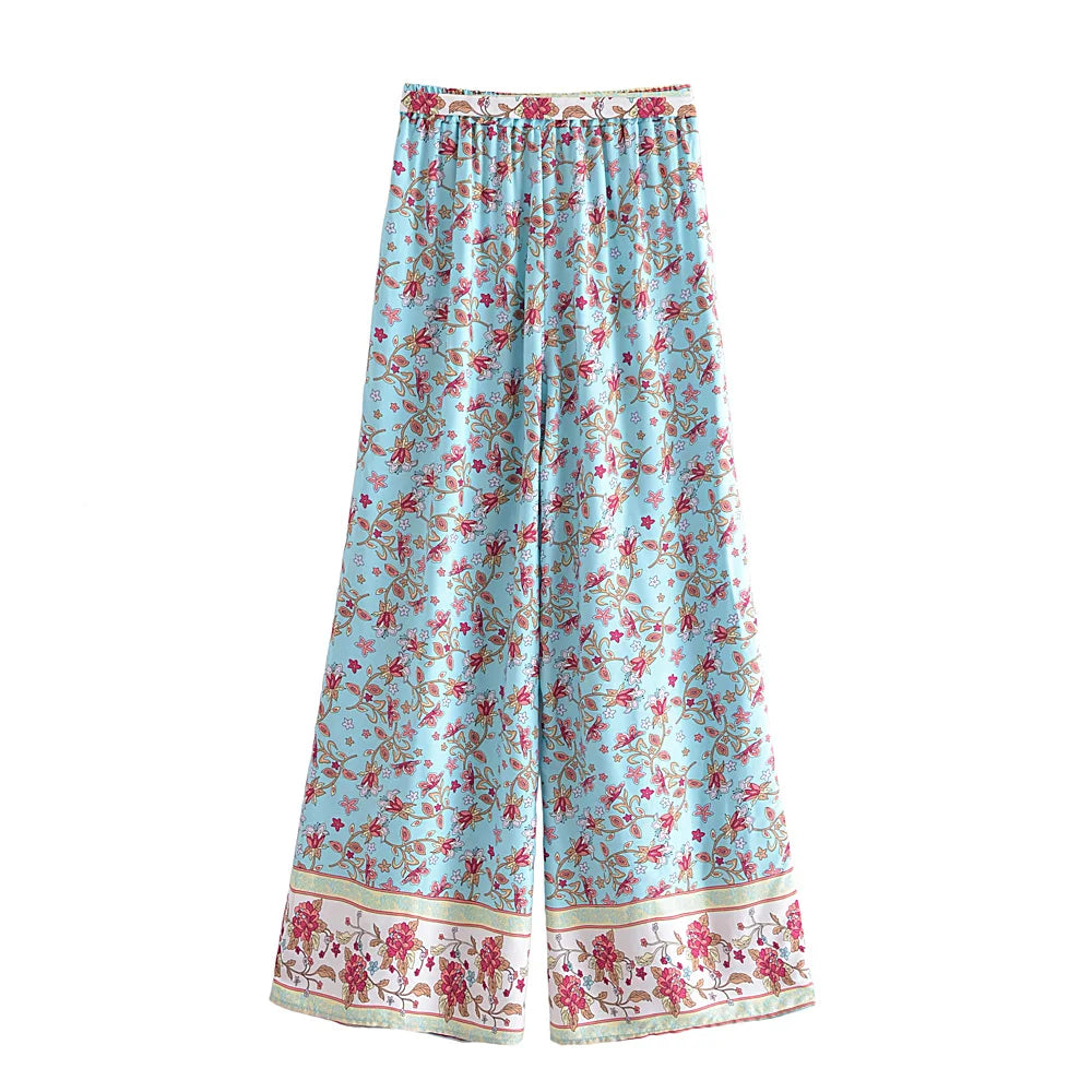Light blue flowy wide leg drawstring pants with pink floral patterns, ideal for a bohemian outfit.