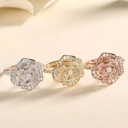 Three pavé-set moissanite camellia flower rings in silver, gold, and rose gold.