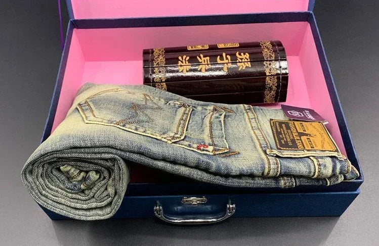 Stretchy blue tapered jeans in midweight denim inside a blue gift box for daily comfort.