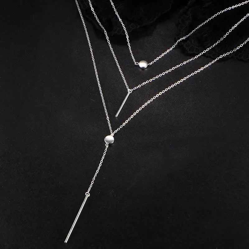 Women's gold-tone layered chain necklace with pendant detail